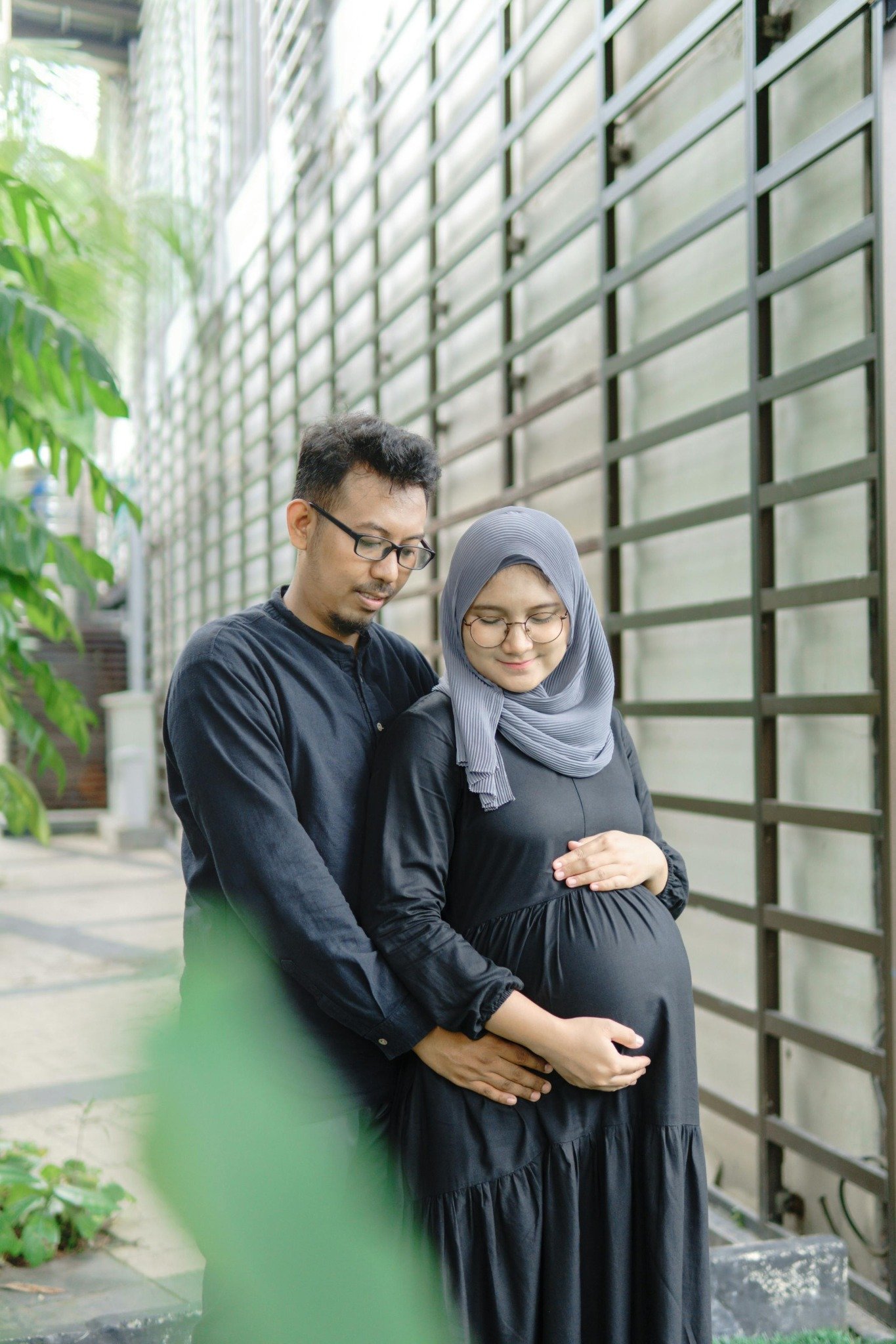 Pregnant couple standing together outdoors