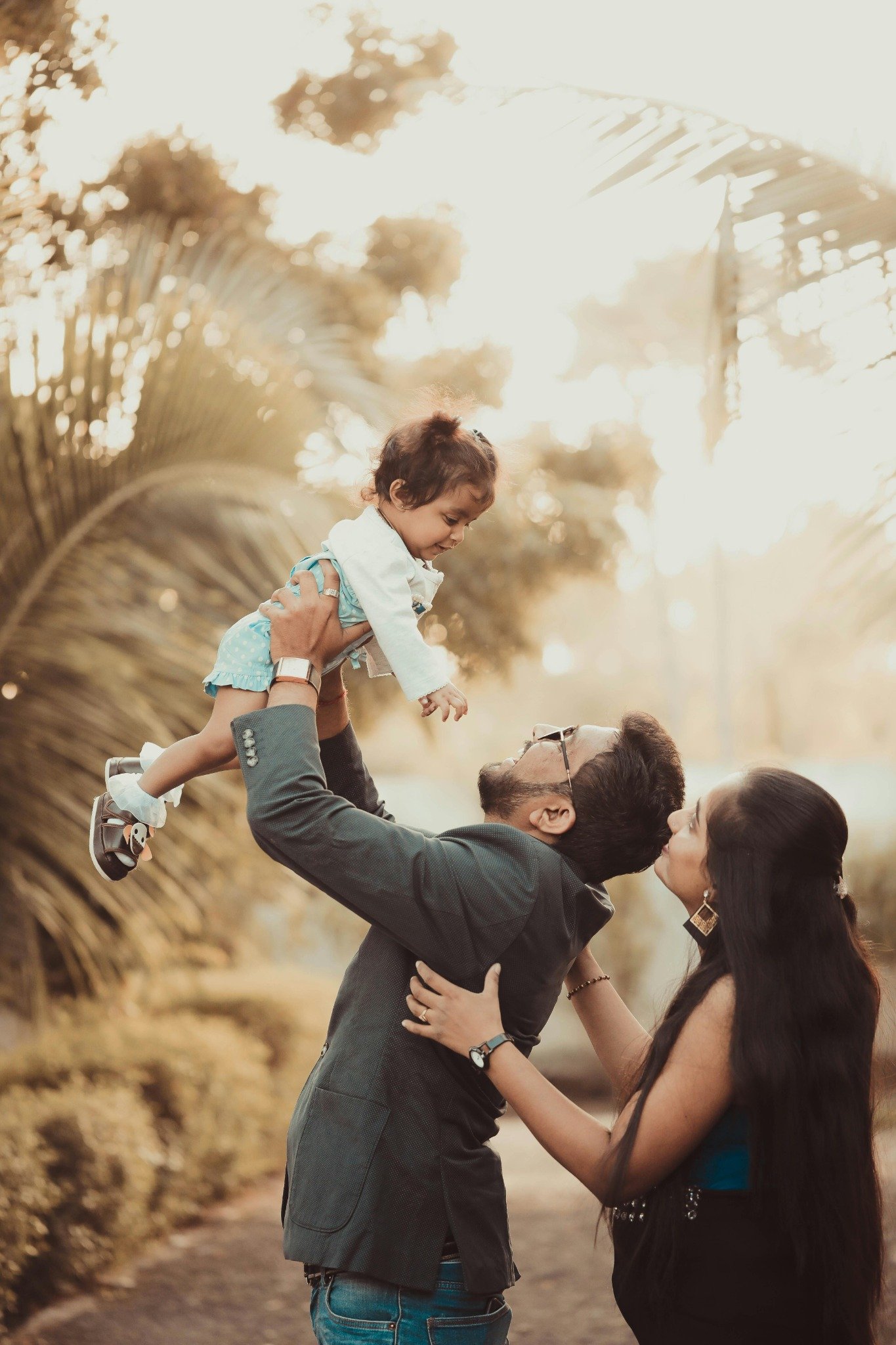 Parents playing with their child outdoors